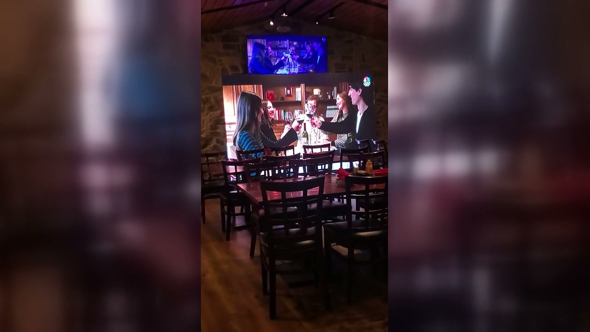 Indoor LED wall install at bar/restaurant showing NBC Olympics broadcast and beverage promo